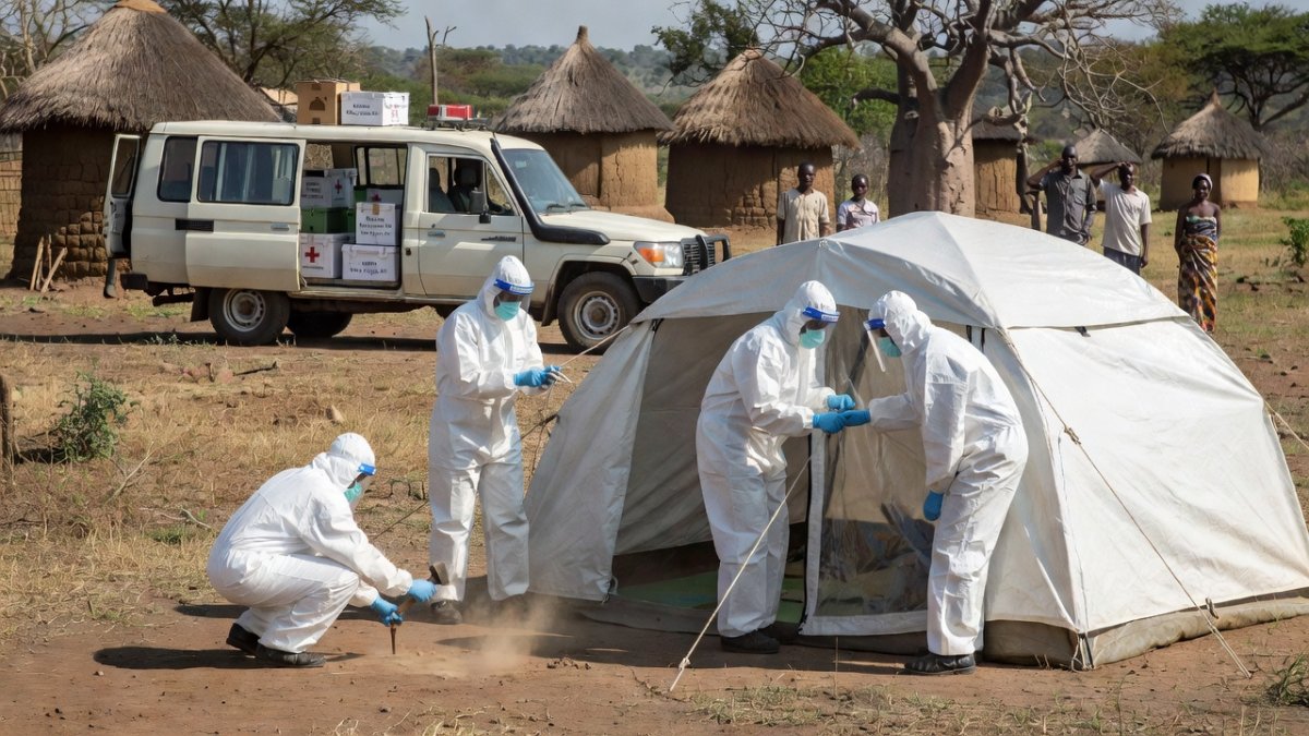Health workers in full PPE setting up isolation tents in rural Ituri, eastern DRC
