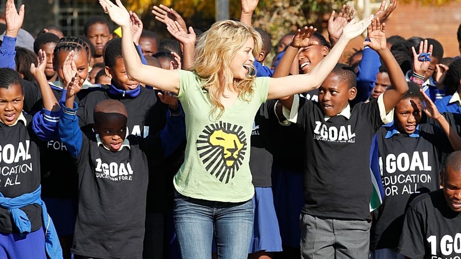 Shakira dancing with children during a World Cup promotional event