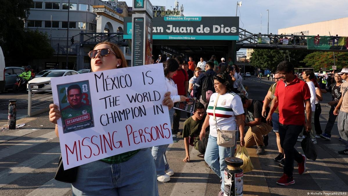 A woman holds a sign during a protest seeking to draw attention to Mexico's missing people during the 2026 World Cup in Guadalajara