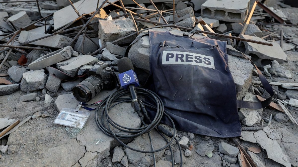 Palestinian press credentials and media equipment symbolizing press freedom under threat in Gaza