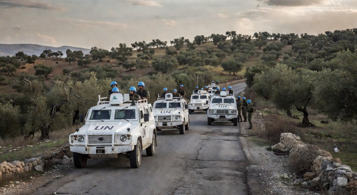 UN peacekeeping vehicles in southern Lebanon with hills and olive groves