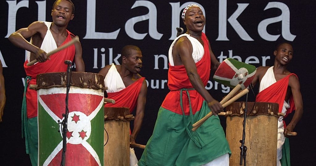 Drummers balancing royal drums during the UMUKOZO Festival street carnival