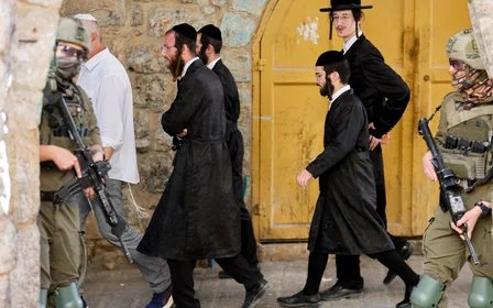 Israeli soldiers stand guard during a weekly settlers tour in Hebron, occupied West Bank