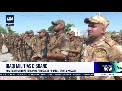 Iran-backed Iraqi militia members at a handover ceremony with Iraqi security forces