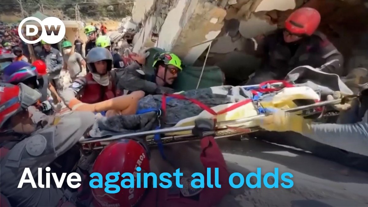 Members of Mexico's Topos rescue brigade search for survivors in rubble in La Guaira, Venezuela