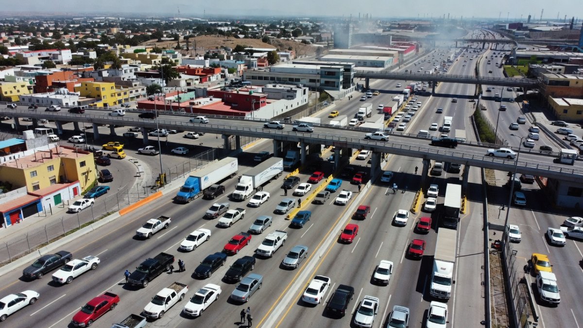 Aerial view of US-Mexico border crossing with vehicles and checkpoint