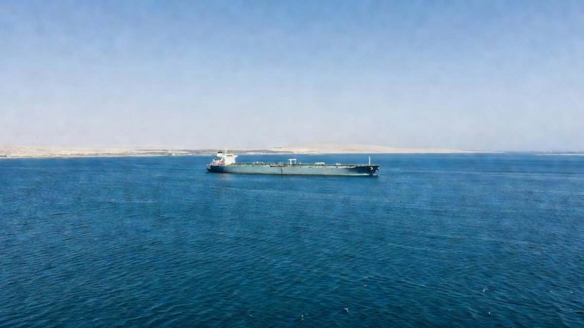 Aerial view of the Strait of Hormuz waterway with oil tanker