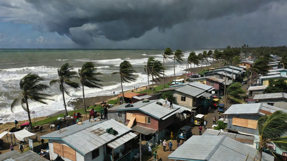 Philippine coastal community preparing for Typhoon Inday with storm clouds approaching