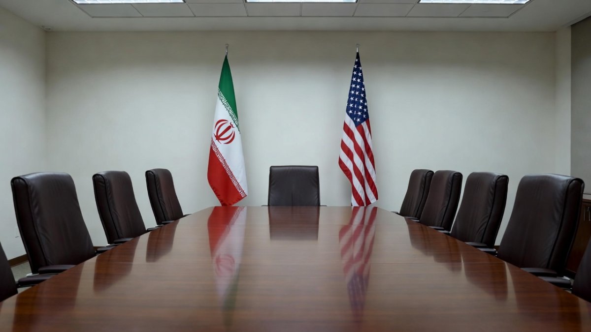 Diplomatic context of US-Iran negotiations with national flags