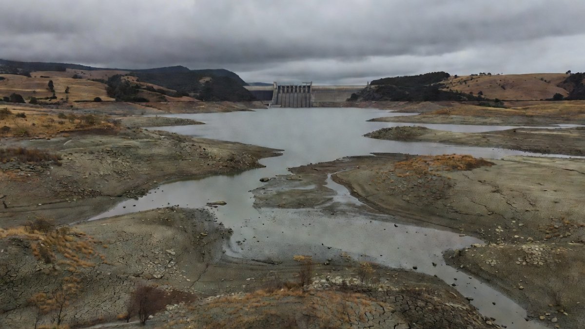 Brazilian hydroelectric dam reservoir with exposed dry banks due to prolonged drought in the Southeast region