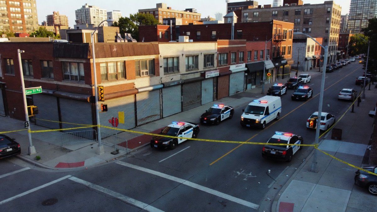 Police vehicles and crime scene tape on St. Clair Avenue West
