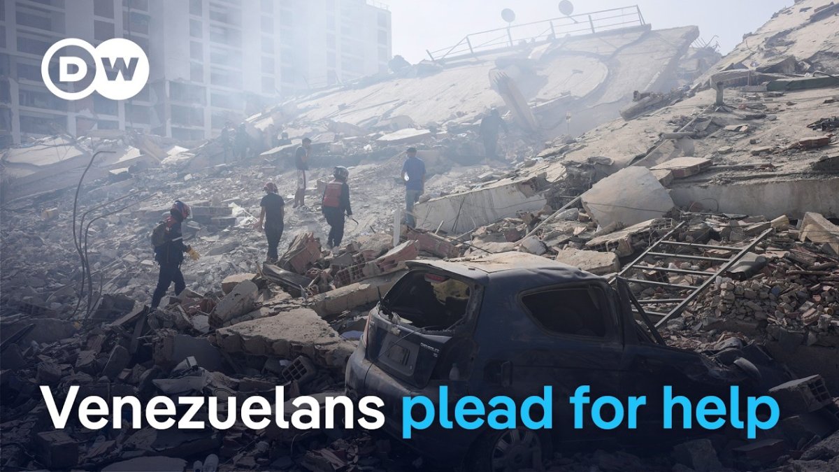 Venezuelan rescue workers and volunteers search through rubble in Caracas