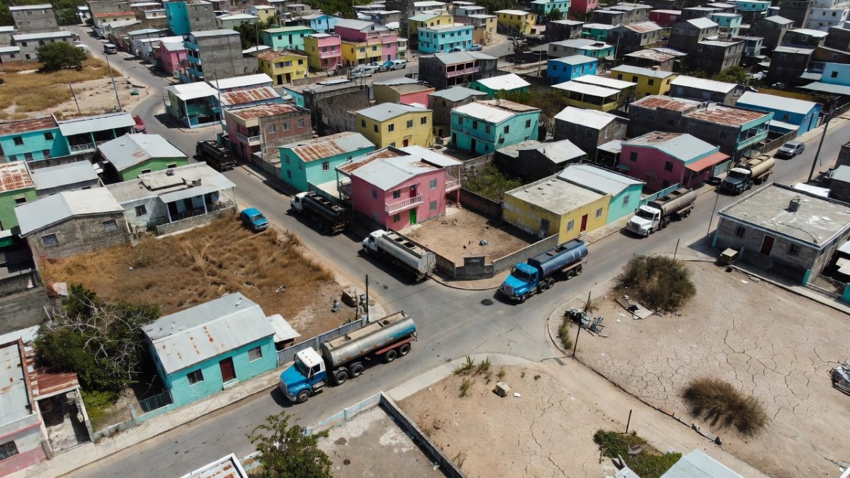 Aerial view of urban landscape in Puerto Rico showing drought conditions and water infrastructure challenges