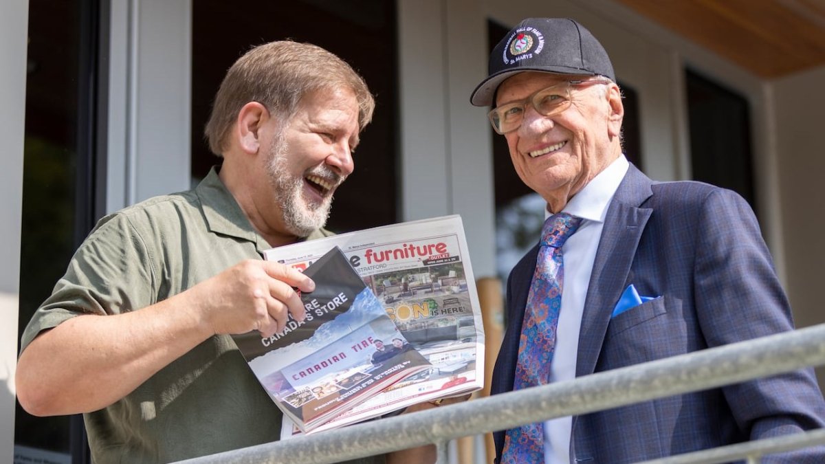 A fan shows Jacques Doucet newspaper clippings at the Canadian Baseball Hall of Fame induction ceremony in St. Marys, Ont.