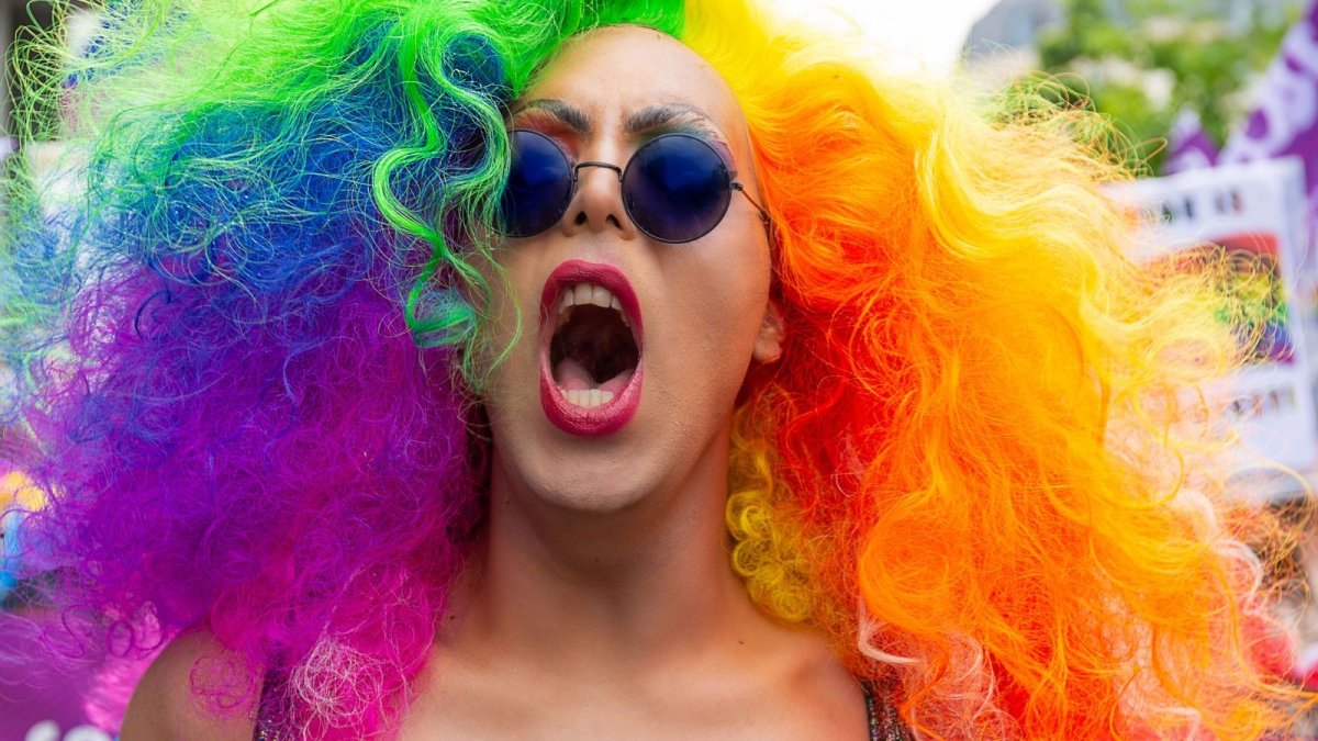 Revellers celebrate at Brighton Pride with rainbow flags and colours