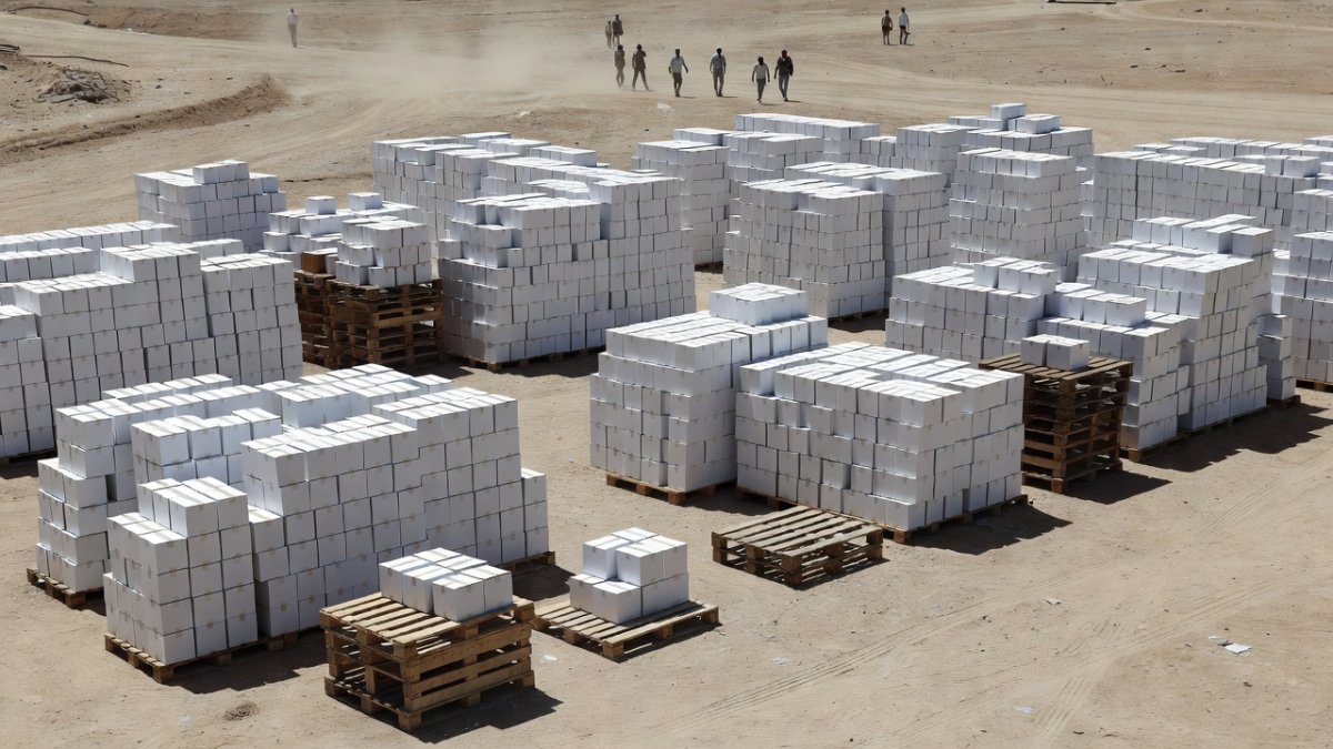 Humanitarian aid supplies stacked for distribution in Gaza