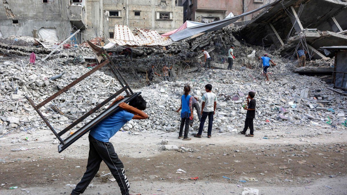 Palestinians salvage belongings from rubble in Gaza after Israeli strikes