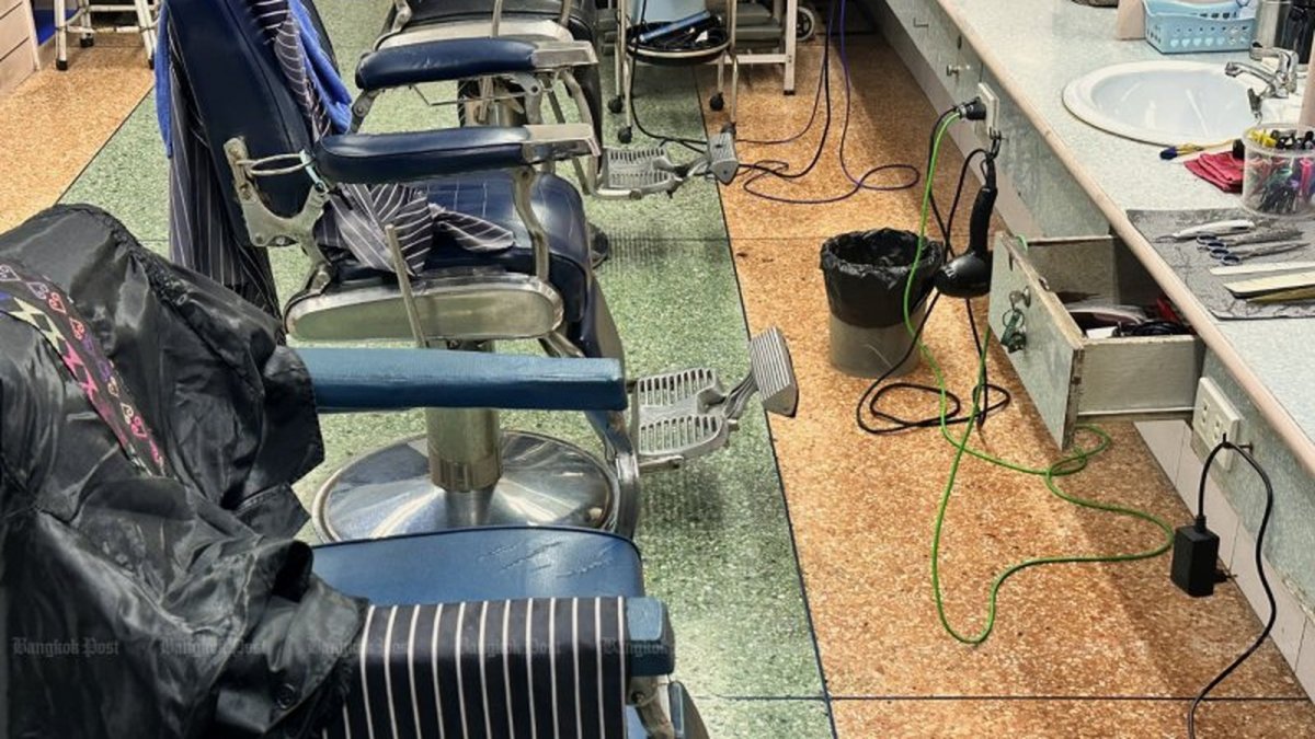 Thai hairdressers at work in a Bangkok neighbourhood salon