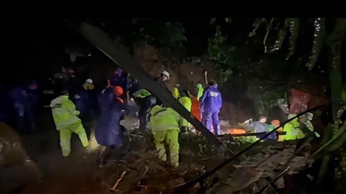 Emergency response teams and volunteers dig through soil and debris in the Baguio City landslide rescue operation
