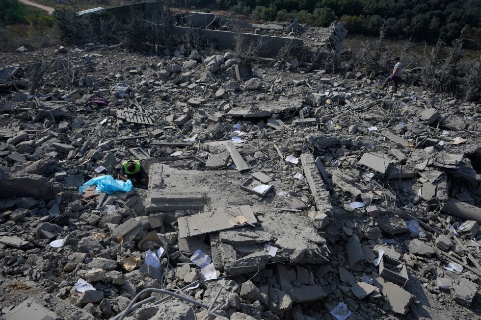 Rescue workers search through the rubble of a home hit by an Israeli airstrike in Ansar village, southern Lebanon, on 15 August 2026