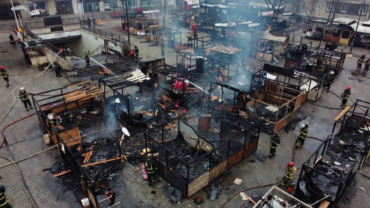 A burned second-hand market in Kyiv after a Russian strike, with hundreds of stalls reduced to rubble