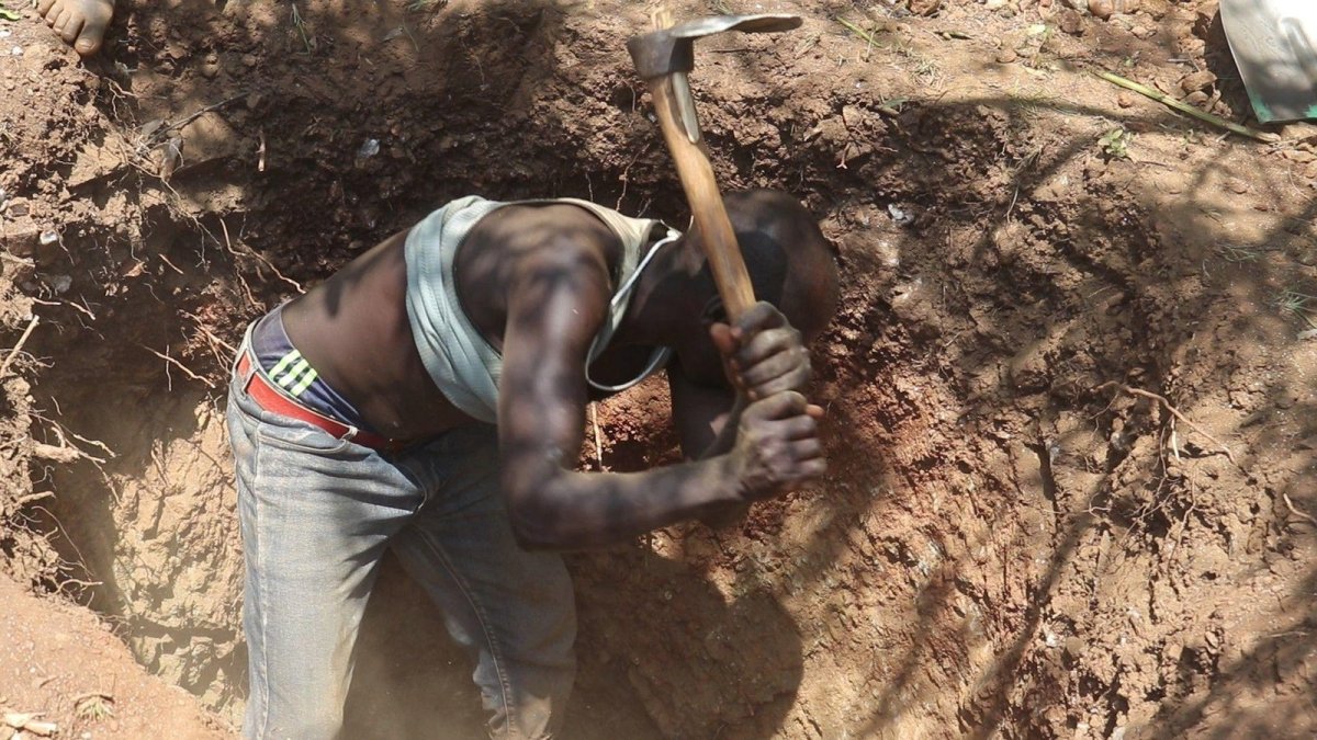 Prospectors work pits and mounds at the Cheporor gold rush site in West Pokot county, Kenya