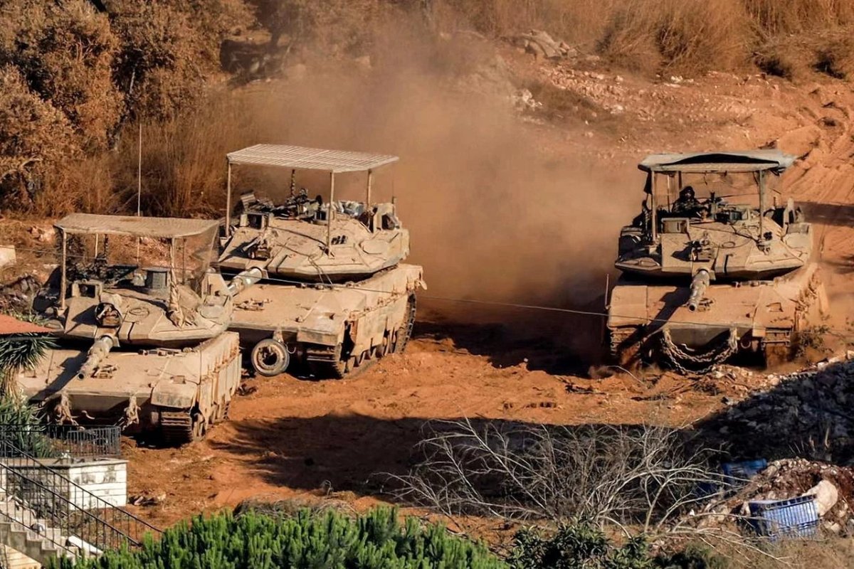 Israeli battle tanks deploy near Zawtar al-Sharqiyah, southern Lebanon, as seen from Zawtar al-Gharbiyah