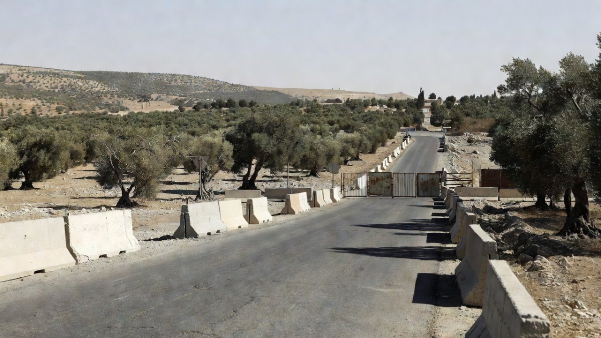 Closed road and concrete barriers near olive groves in the occupied West Bank