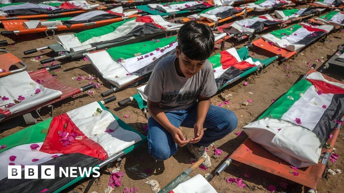 Rows of coffins draped in Palestinian flags at the mass funeral in Gaza City