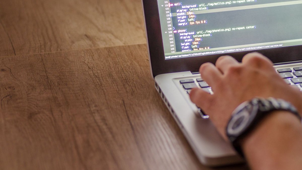 Developer coding on a laptop during a late-night work session