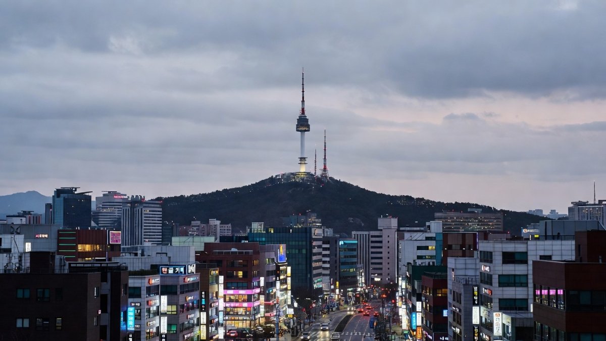 Seoul skyline at dusk, symbol of Korea's cultural soft power