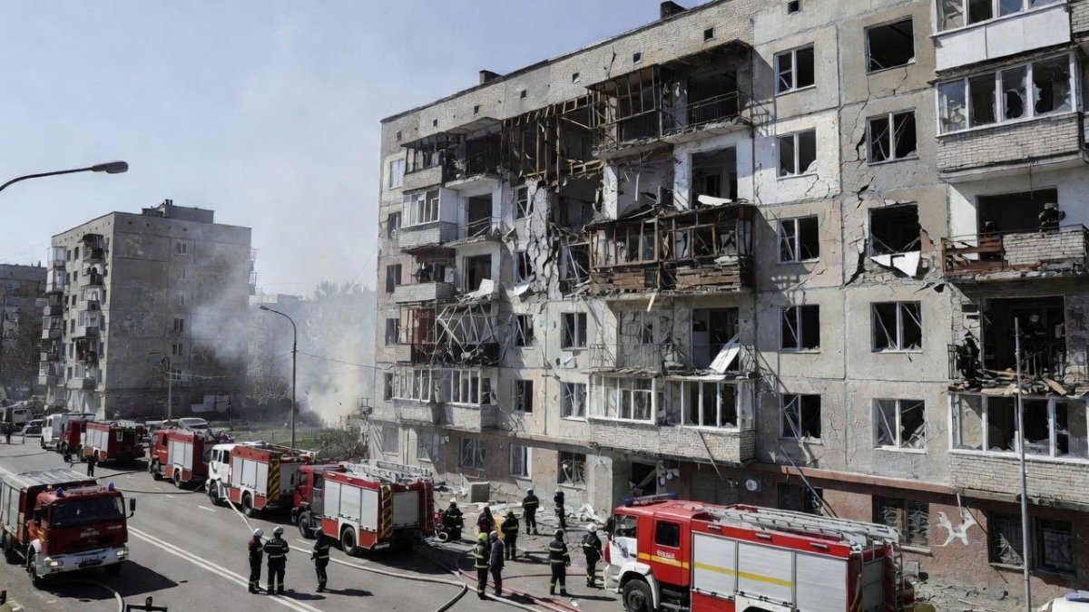 Rescue workers at a damaged apartment building in Solomianskyi district