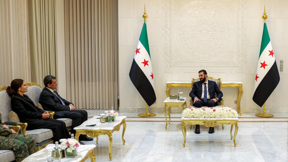 Syrian President Ahmed al-Sharaa and former SDF commander Mazloum Abdi during the integration announcement in Damascus