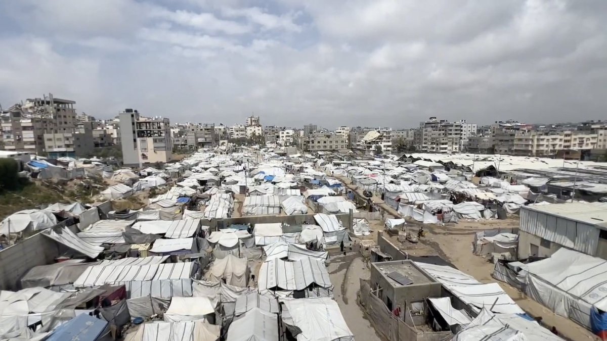 Displaced families shelter in tents amid rubble and waste in Gaza