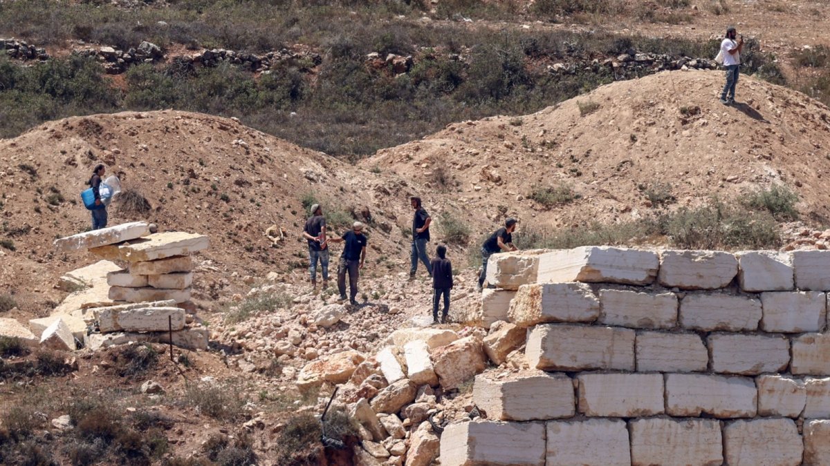 Louai Abu Ridi at his family home in Qusra, where an American flag flies above the house during the settler siege