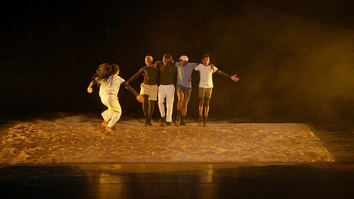 Via Katlehong dancers perform Tamujuntu on a sand-covered stage at Maison de la Danse in Lyon