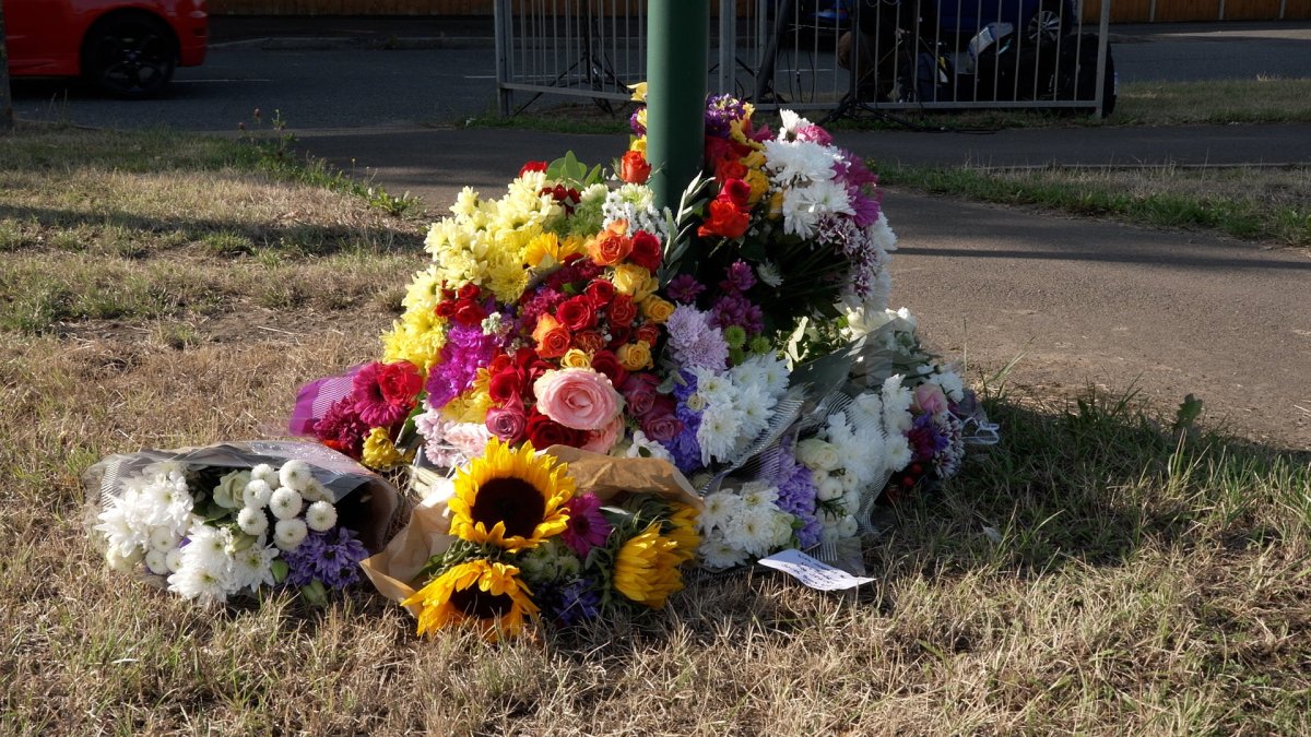 Cleveland Police crest and floral tributes outside a police station