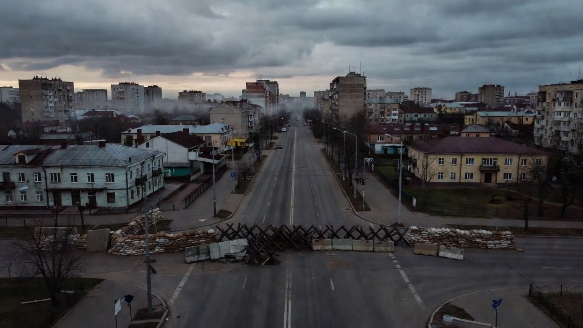 A military checkpoint on a Ukrainian city street at dawn
