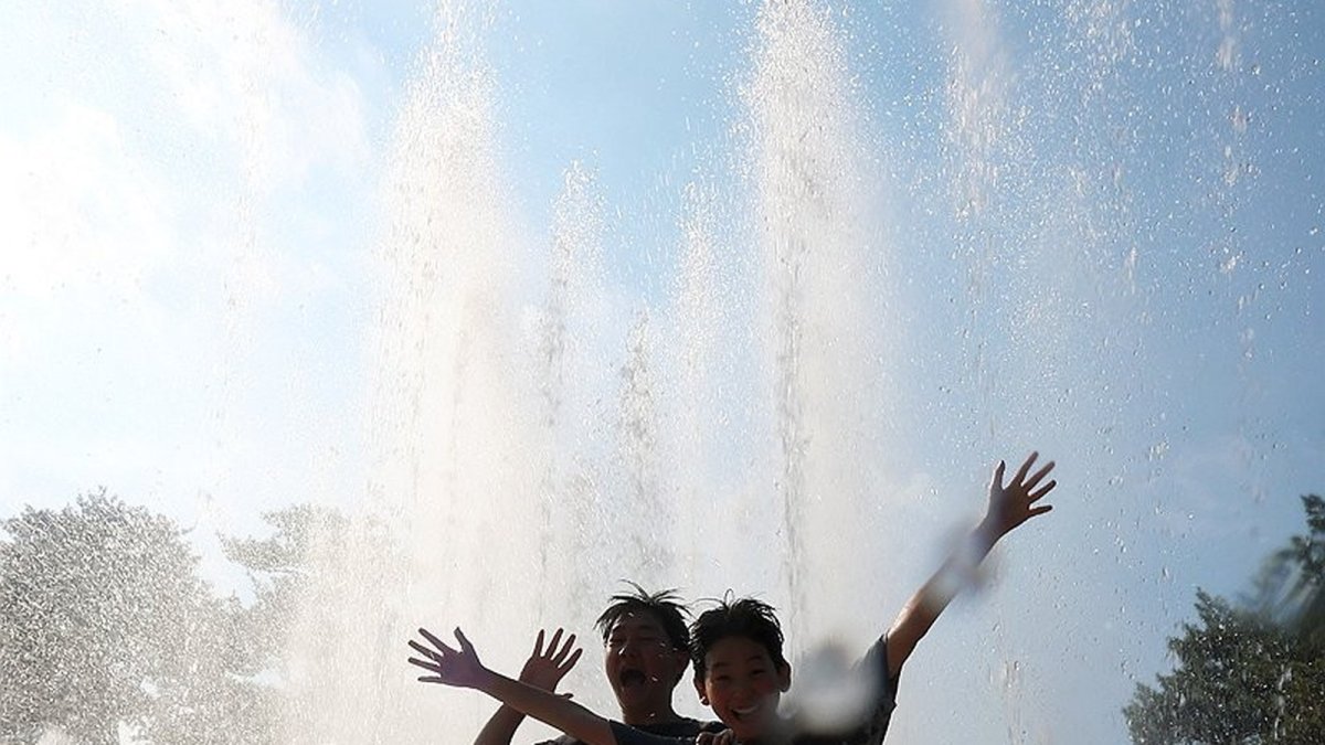 Children cool off at a fountain in Yangsan amid record heatwave