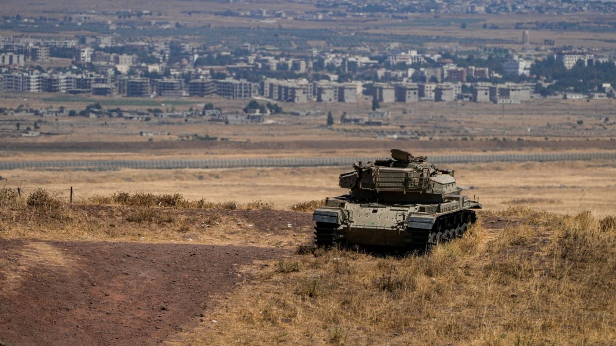 An Israeli tank stands in position near the cease-fire line in the Israeli-occupied Golan Heights, Syria