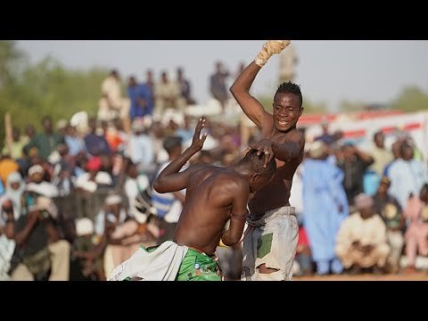 A traditional Dambe boxing match at Nigeria's Argungu festival, where fighters use the wrapped spear fist and open shield hand
