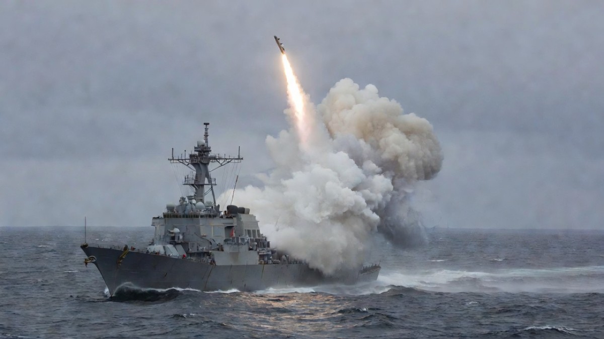 A U.S. Navy destroyer launching a Tomahawk cruise missile at sea