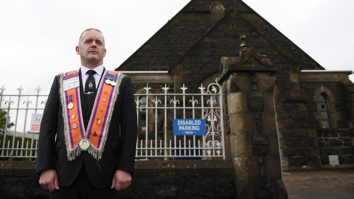 A member of the Orange Order outside Drumcree Church in Portadown, where the return parade was delayed for hours on Sunday. Photo: RTE