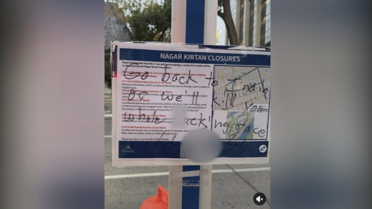 A City of Winnipeg sign advising of Nagar Kirtan road closures, defaced with hateful graffiti including a swastika and threats