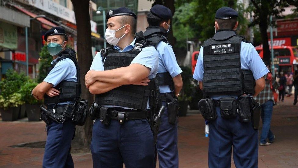 Police officers standing guard in the Causeway Bay district of Hong Kong