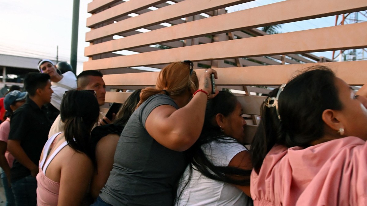 Relatives of detained fishermen wait outside a Community Surveillance Unit in Manta, Ecuador, seeking news of crew members