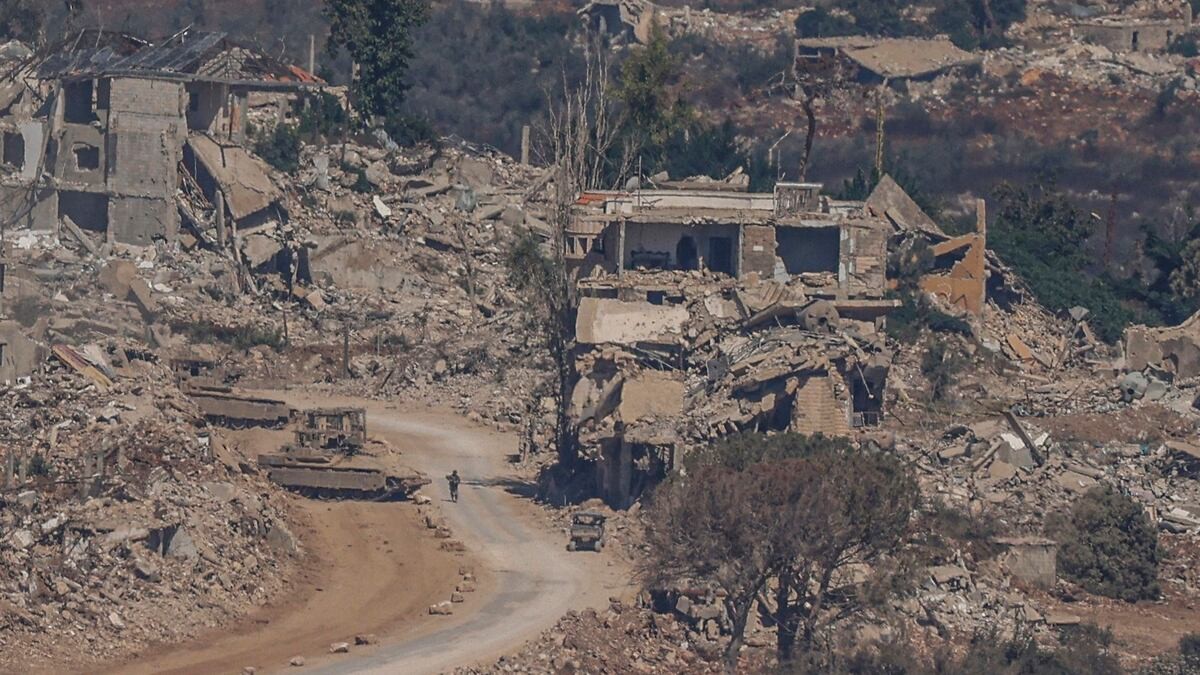 Destroyed buildings and Israeli military vehicles in a village in southern Lebanon