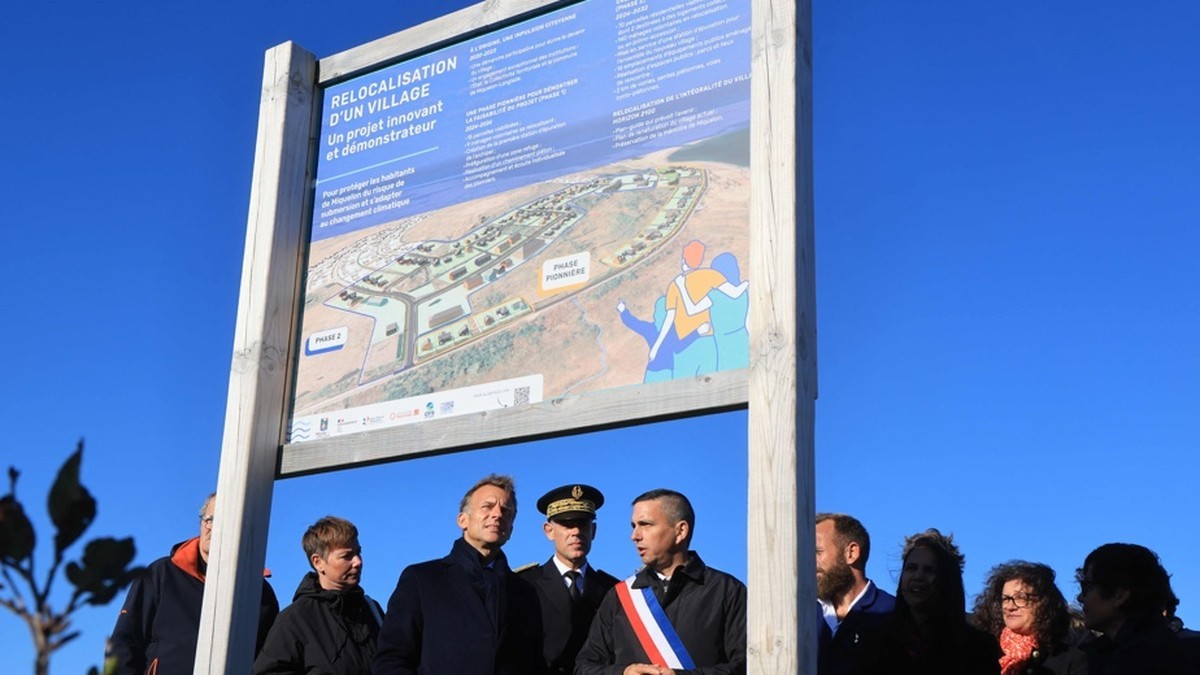 French President Emmanuel Macron reacts alongside local officials, including Miquelon mayor Franck Detcheverry, as he is shown a housing construction plan for the new village of Miquelon on 20 September 2026. Photo: Ludovic Marin/AFP via La Presse