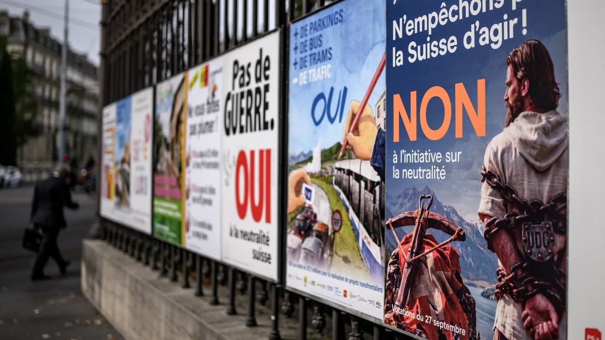 Campaign posters on a street fence ahead of Switzerland's 27 September 2026 federal vote. Photo: Getty Images via NPR