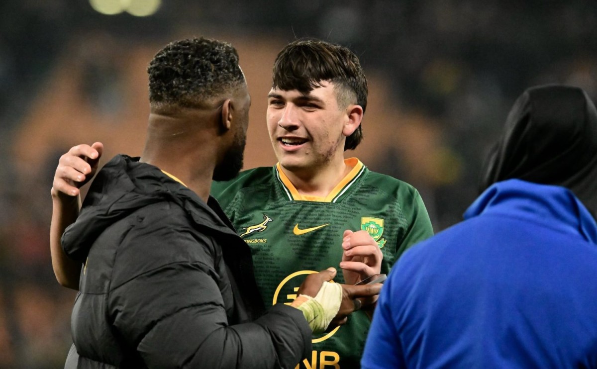 Siya Kolisi poses for a selfie with a Springbok supporter who ran onto the field at FNB Stadium